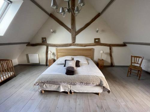 a bedroom with a large bed in a attic at Villas Les Loges in Les Loges