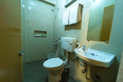 a bathroom with a toilet and a sink at Vivera Highlands in Kodaikānāl