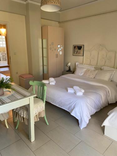 a bedroom with a large bed with a table and a chair at Thalassa in Monodhéndrion