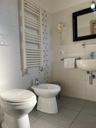 a white bathroom with a toilet and a sink at Cà Dei Barcaroli in Mestre