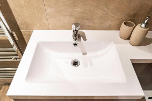 a white sink with a faucet in a bathroom at Camden Apartments 1 in Liverpool