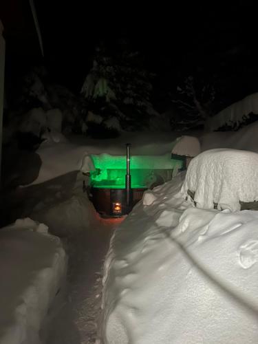 a truck covered in snow with a green light at Wellness penzion Harmonie Rohanov in Prachatice