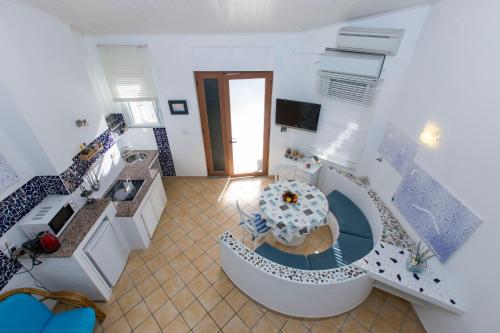 a kitchen with a spiral staircase with a table at Residence Le Terrazze in Sorrento