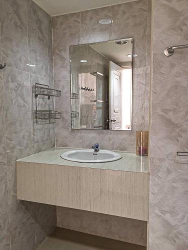 a bathroom with a sink and a mirror at Tower Resident in the Heart of Bangkok Shopping Center in Makkasan