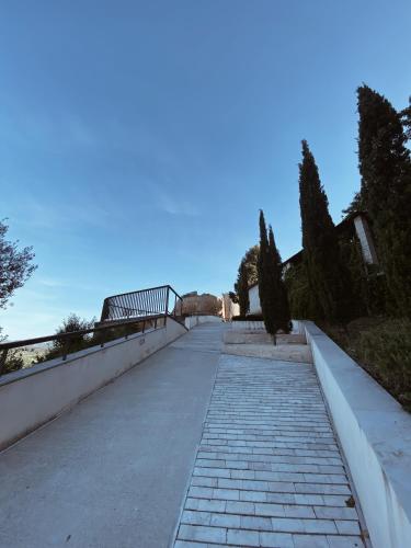 a walking path with a bridge in the background at Casa Cardona in Móra d'Ebre