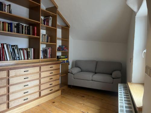 a living room with a couch and book shelves at Haus Messern in Rittersdorf