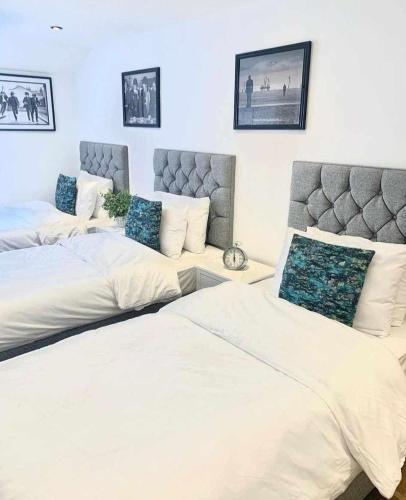 a bedroom with two beds and a couch at Camden Apartments 2 in Liverpool
