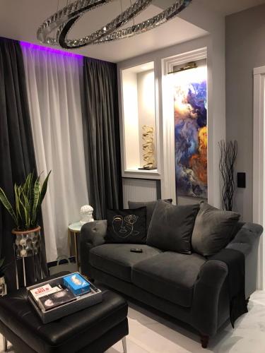 a living room with a couch and a table at B & K Luxury & Elegant Volos Suite in Volos