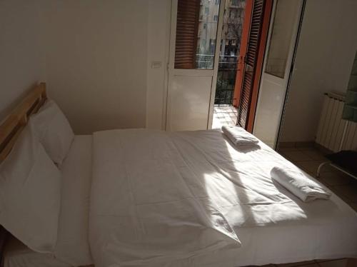 a white bed with two pillows on top of it at Via Creti & Via Mazza Rooms in Bologna