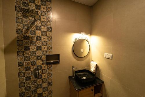 a bathroom with a sink and a mirror on the wall at Vivera Highlands in Kodaikānāl