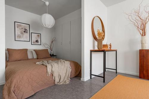 a bedroom with a bed with a mirror and a table at Charming Apt in Sodermalm in Stockholm