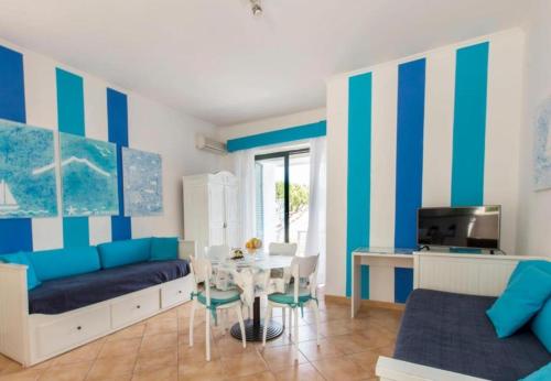 a living room with blue and white striped walls at Residence Le Terrazze in Sorrento