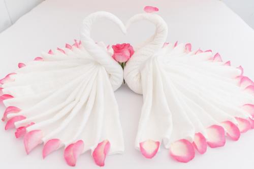 two white swan wings with a pink rose at Quốc Thắng Hotel in Vung Tau