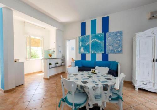 a blue and white dining room with a table and chairs at Residence Le Terrazze in Sorrento