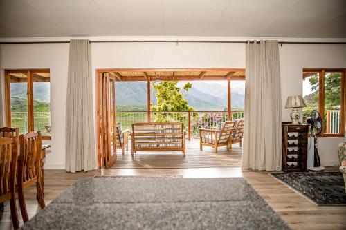 a living room with a view of the mountains at Ontevreden Farm in Montagu