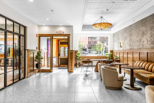 a lobby of a restaurant with tables and chairs at The Phenix DTWN Historic Hotel, Room # 308 in Bangor