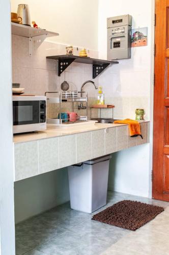 a kitchen with a counter with a microwave at Tower Resident in the Heart of Bangkok Shopping Center in Makkasan