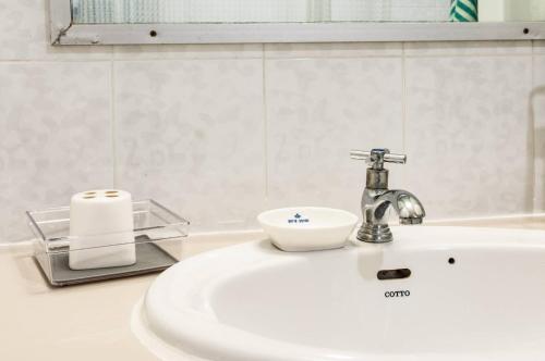 a bathroom sink with a faucet on top of it at Tower Resident in the Heart of Bangkok Shopping Center in Makkasan