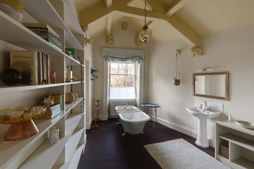 a bathroom with a sink and a toilet and a tub at Eller How House - Private Regency Property & Lake in Lindale