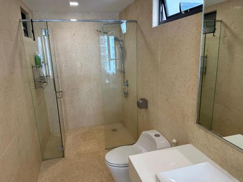a bathroom with a shower and a toilet and a sink at Jazz 2R3B Suite wt Netflix bathtub n Massage Chair in Tanjong Tokong