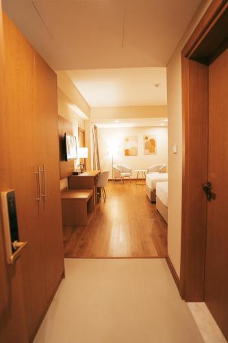 a hotel room with a bed and a living room at AYA Addis Hotel in Addis Ababa