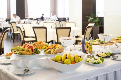 a table with many plates of food on it at Hotel Tatra in Bratislava