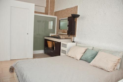 a bedroom with a bed with a sink and a mirror at Urban Harmony Nest in Arona