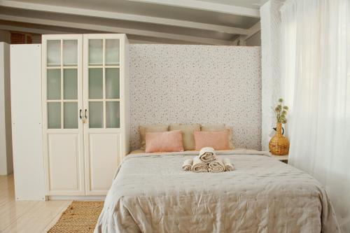 a bedroom with a bed with a teddy bear on it at Studio Ático with Terrace - Heart of Los Cristianos in Arona