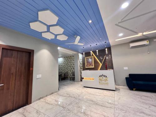 a lobby with a blue ceiling and a blue couch at Hotel Kesari in Sālāsar
