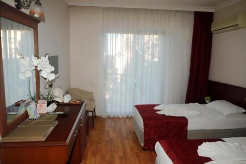 Кровать или кровати в номере ASTORIA PARK HOTEL & Spa ALL INCLUSIVE CONCEPT