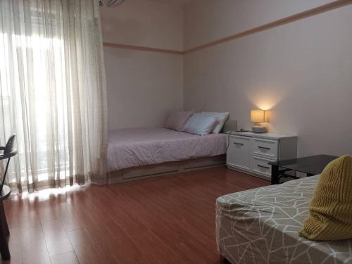 a small bedroom with a bed and a window at Cozy 1br walk to BTS and Airport Rail Link Close to Malls T in Bangkok
