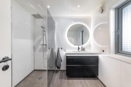 a bathroom with a sink and a mirror at Vikran Seaside Lodge in Straumsjøen