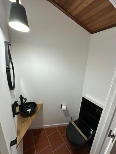 a bathroom with a toilet and a sink at 19 Tile Ceramic Concept - by Unlock Hotels in Caldas da Rainha