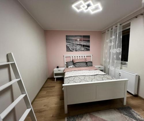 a bedroom with a white bed and a window at Boarding House am Ahnepark in Vellmar