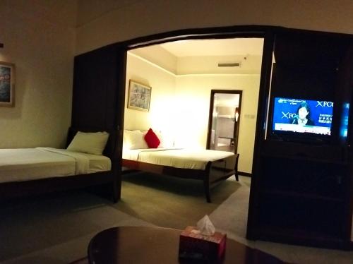 a hotel room with two beds and a tv at CITY APARTMENT at TIMES SQUARE in Kuala Lumpur