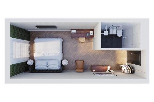 een kleine kamer met een bed en een keuken bij Hotel Akureyri in Akureyri