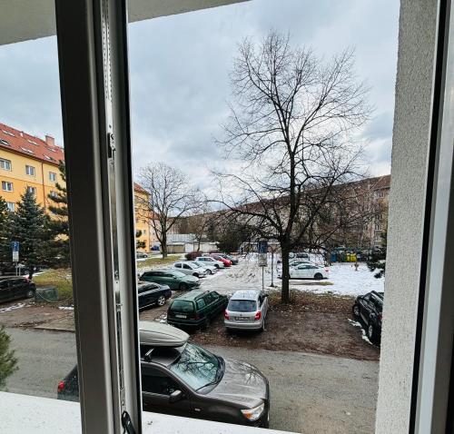 a window view of a parking lot with cars parked at Provence style apartment in Košice