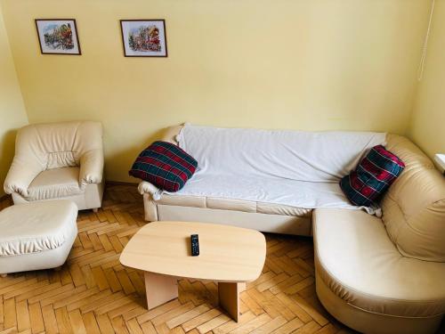 a living room with a couch and a coffee table at Provence style apartment in Košice