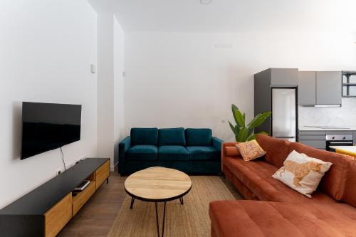 a living room with a couch and a table at Luxe Apartment Madrid North in Madrid