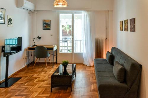 a living room with a couch and a table at Renovated Kypseli Apartment in Athens