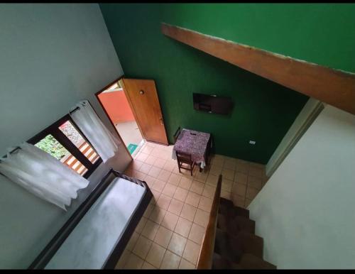 an overhead view of a room with a table and green walls at Pousada Pé da Mata Maresias in Maresias
