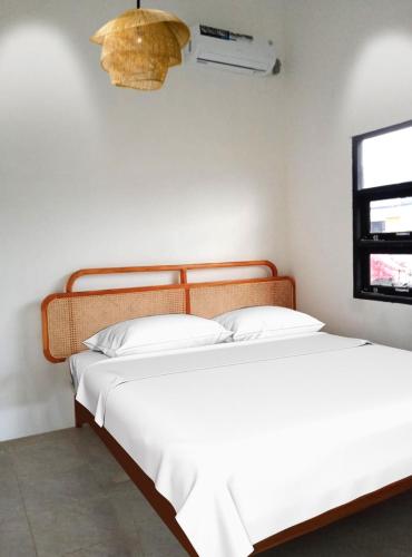 two beds sitting next to each other in a room at El Sierra Villa in Pontianak