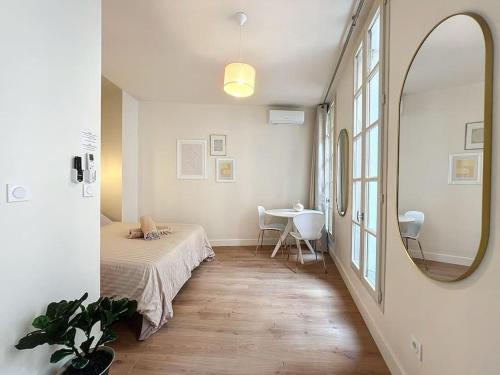 une chambre avec un lit, un miroir et une table dans l'établissement Élegant Appartement - Hyper Centre & Climatisation - Les Frères de la Loc', à Marseille