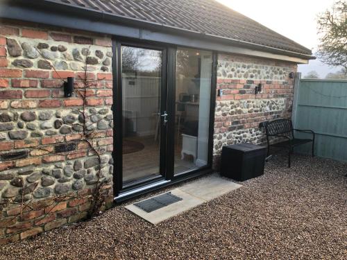 a sliding glass door on the side of a brick building at The Studio in Harrogate