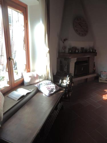 a living room with a bench and a clock on the wall at Il Paiolo Incantato in Bracciano