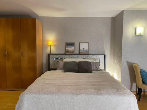 a bedroom with a large bed with two pillows at Grand Residence in Bangkok