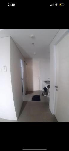 a white room with a hallway with a door and a room with a room at By thor Bintaro plaza residance in Pondoklang