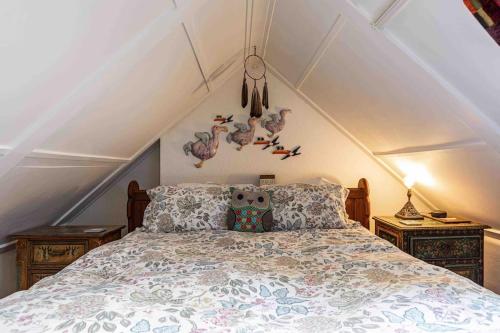 a bedroom with a bed in a attic at Quaint & Cozy Cottage, Private garden & bike shed in Innerleithen