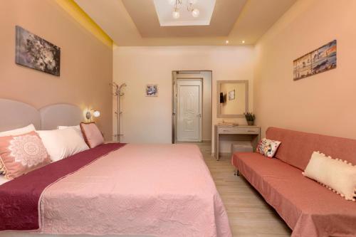a bedroom with a bed and a couch at Mary Elen Boutique Hotel in Argasi