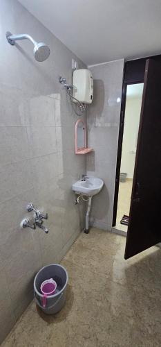 a bathroom with a sink and a shower and a mirror at SAIBALA HOMESTAY - AC 1 BHK NEAR AlRPORT in Chennai